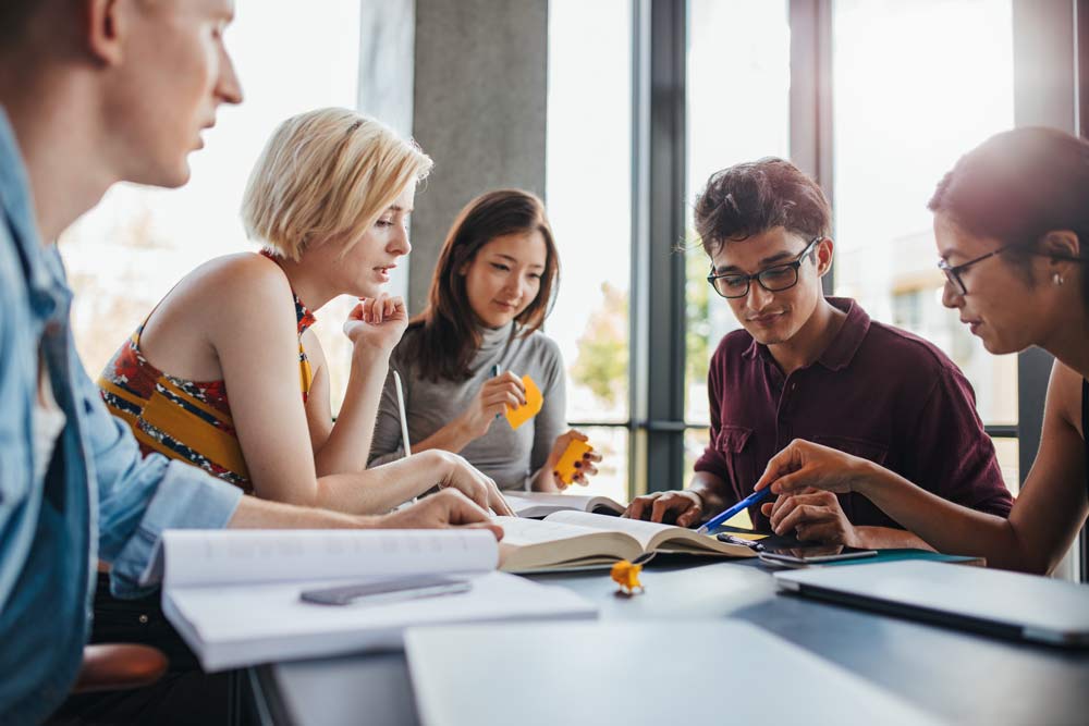 Students studying together in a group study room at Life Chiropractic College West